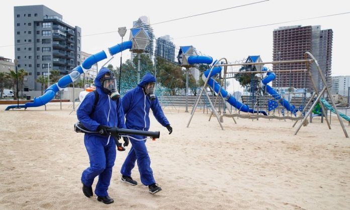 x87554145_TOPSHOTMunicipal-employees-spray-disinfectant-in-a-children-playground-in-the-Israeli-co.jpg.pagespeed.ic.lA-sEh7mjZ